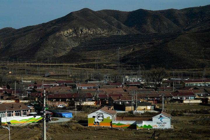 The Beijing Winter Olympics mascot, Bing Dwen Dwen, and the Olympic rings are painted on the walls of homes in a small village ahead of the 2022 Winter Olympics on Jan. 30.