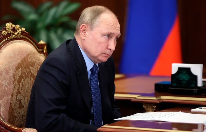 Russian President Vladimir Putin listens to Minister of Justice Konstantin Chuychenko during their meeting in the Kremlin in Moscow, Russia, Monday, Jan. 31, 2022. (Mikhail Metzel, Sputnik, Kremlin Pool Photo via AP)