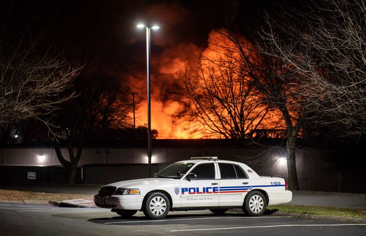 A Winston-Salem police car is parked near a fire at the Weaver Fertilizer Plant on Monday in Winston-Salem, N.C.