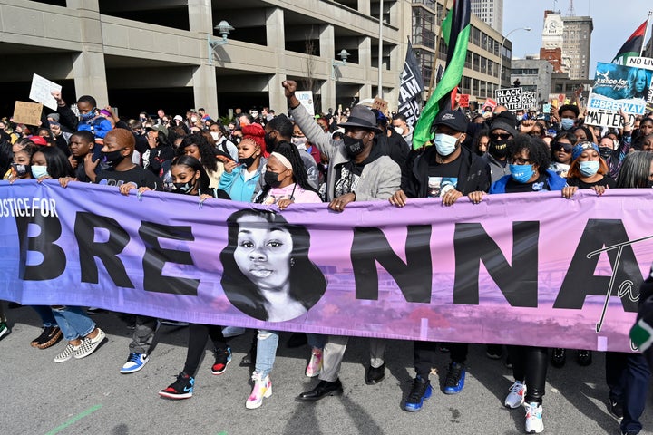 In this March 13, 2021 file photo, Tamika Palmer, center, the mother of Breonna Taylor, leads a march through the streets of downtown Louisville on the one year anniversary of her death in Louisville, Ky.