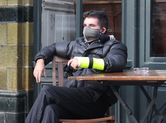 Simon was also seen with his cast outside a local pub
