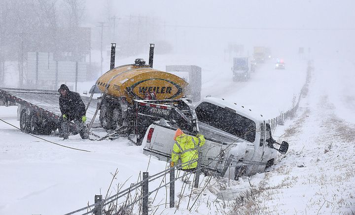ATR Towing and Recovery workers remove a pickup truck that slid into the median on Interstate 70 on Wednesday after a winter storm dumped about seven inches of snow on St. Louis, Mo. Another four to seven inches of snow is expected tonight and Thursday. 