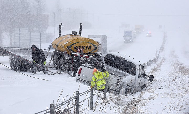 Winter Storm Closes Schools, Snarls Travel For Millions Of
Americans 2 ATR Towing and Recovery workers remove a pickup truck that slid into the median on Interstate 70 on Wednesday after a winter storm dumped about seven inches of snow on St. Louis, Mo. Another four to seven inches of snow is expected tonight and Thursday.