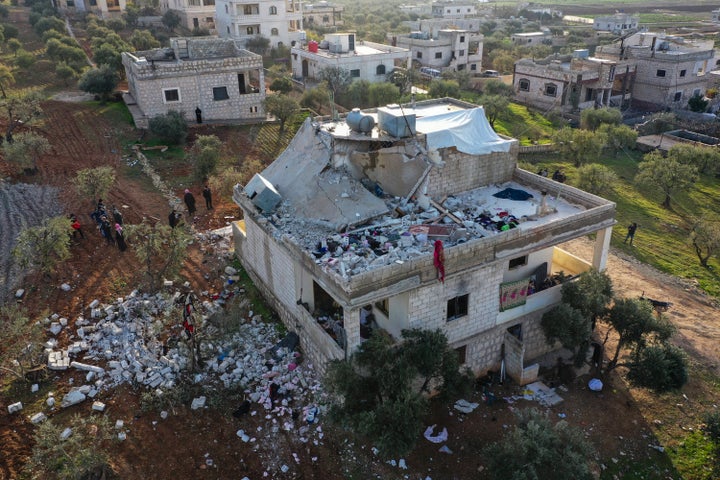 People inspect a destroyed house following an operation by the U.S. military in the Syrian village of Atmeh, in Idlib province, Syria, on Feb. 3, 2022.