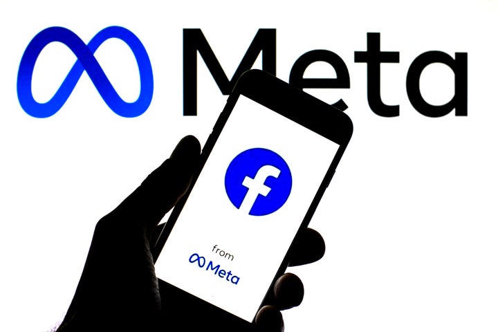 In this photo illustration a Facebook and Meta logo seen displayed on a smartphone with a Meta logo in the background. (Photo Illustration by Thiago Prudencio/SOPA Images/LightRocket via Getty Images)