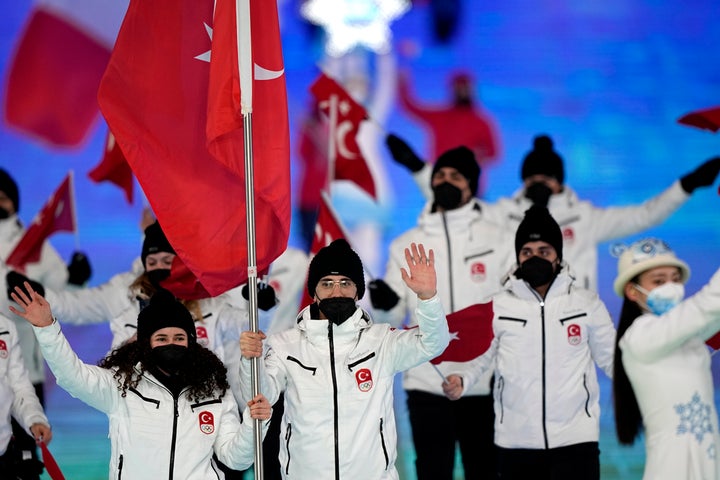 Furkan Akar and Aysenur Duman, of Turkey, lead their team in during the opening ceremony of the 2022 Winter Olympics, Friday, Feb. 4, 2022, in Beijing. (AP Photo/David J. Phillip)