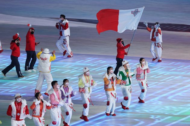 BEIJING, CHINA - FEBRUARY 04: Flag bearer Jenise Spiteri of Team Malta waves their flag during the Opening Ceremony of the Beijing 2022 Winter Olympics at the Beijing National Stadium on February 04, 2022 in Beijing, China. (Photo by Julian Finney/Getty Images)