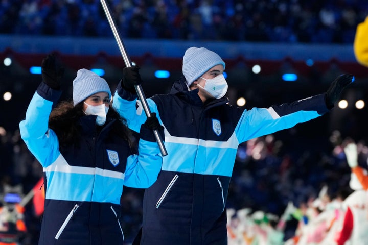 Matteo Gatti and Anna Torsani, of San Marino, carry their national flag into the stadium during the opening ceremony of the 2022 Winter Olympics, Friday, Feb. 4, 2022, in Beijing. (AP Photo/Natacha Pisarenko)