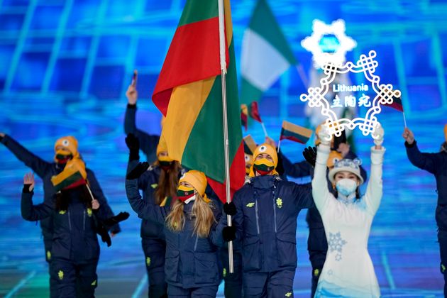 Deividas Kizala and Paulina Ramanauskaite, of Lithuania, lead their team in during the opening ceremony of the 2022 Winter Olympics, Friday, Feb. 4, 2022, in Beijing. (AP Photo/David J. Phillip)