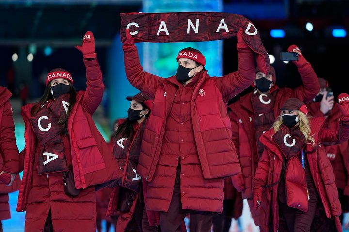 Athletes from Canada walk into the stadium during the opening ceremony of the 2022 Winter Olympics, Friday, Feb. 4, 2022, in Beijing. (AP Photo/Jae C. Hong)