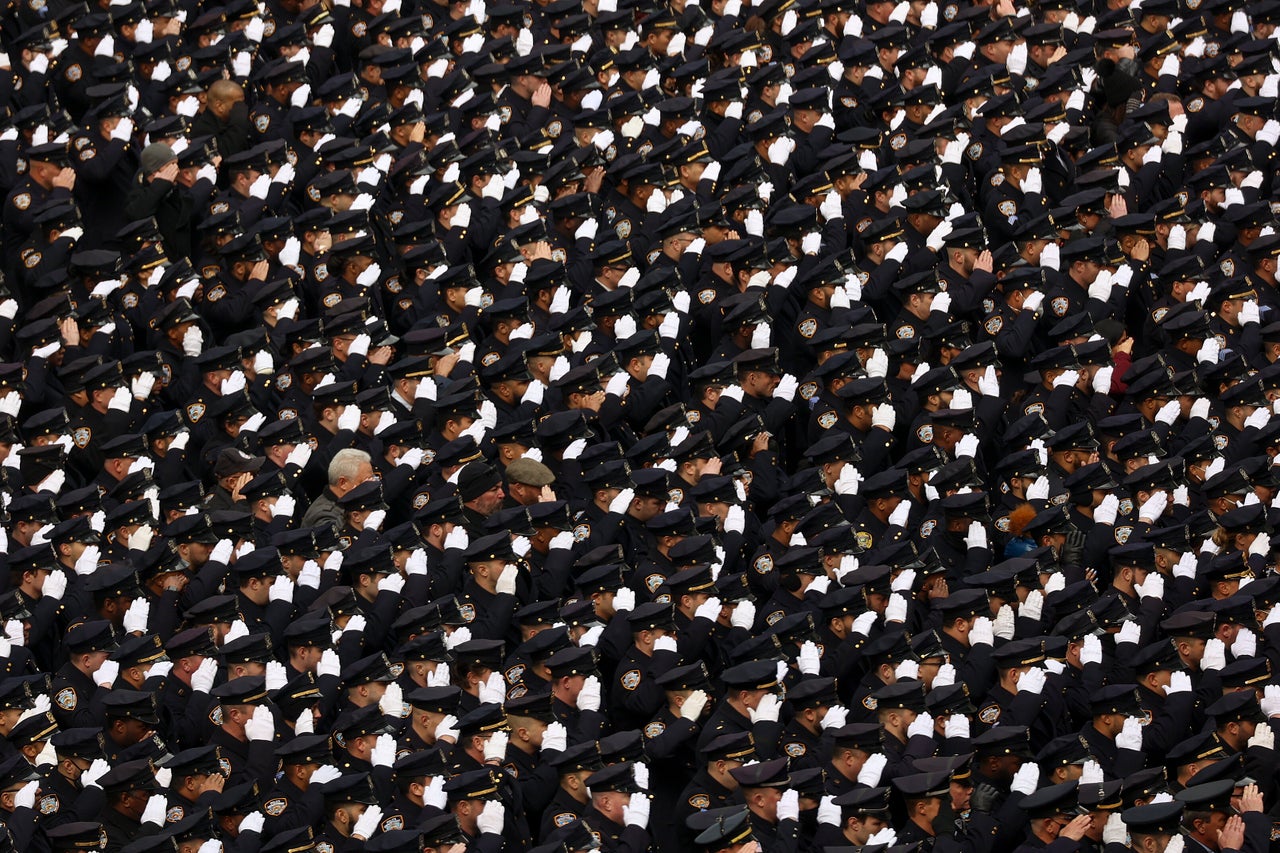 New York Police officers salute outside St. Patrick's Cathedral after a funeral service for Officer Wilbert Mora on Wednesday. For the second time in less than a week, police converged on the cathedral to pay tribute to a young officer gunned down while answering a call for help. Mora was shot along with Officer Jason Rivera on Jan. 22 while responding to a call about a domestic argument in a Harlem apartment.