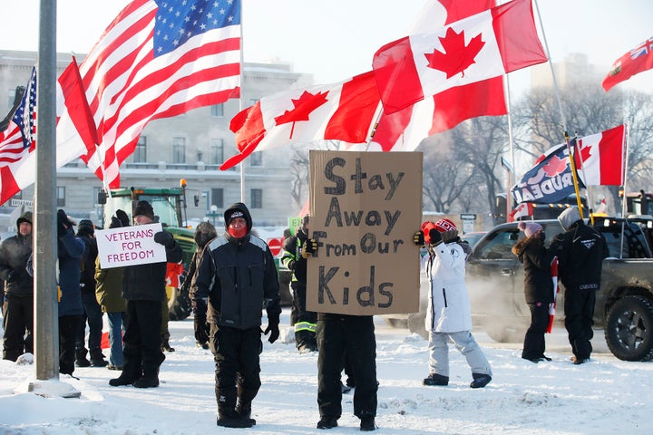 Demonstrators rally against provincial and federal COVID-19 vaccine mandates and in support of Ottawa protestors, Friday, Feb. 4, 2022, outside the Manitoba Legislature in Winnipeg, Manitoba. (John Woods/The Canadian Press via AP) qhiukiuiqkeinv