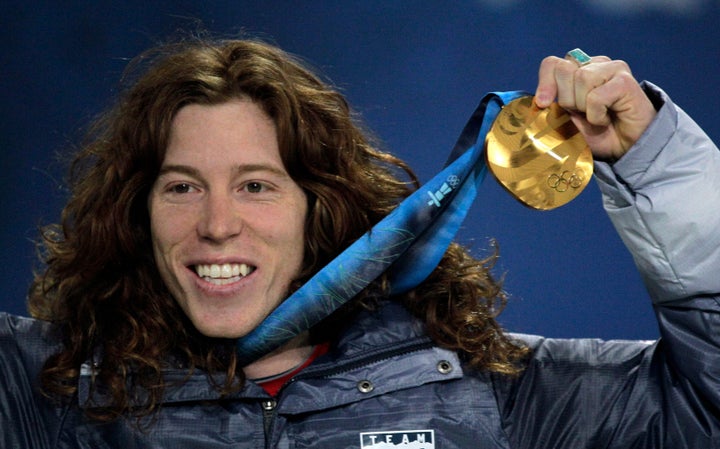 Shaun White reacts during the men's halfpipe medal ceremony at the Vancouver 2010 Olympics.