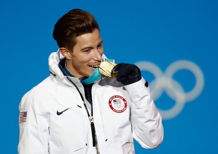 Shaun White bites his medal during the medals ceremony at the 2018 Winter Olympics in Pyeongchang, South Korea.