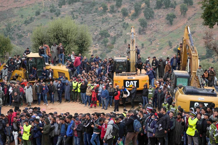 Residents stand on top of tractors as they watch civil defense workers and local authorities attempting to rescue a 5-year-old boy who fell into a hole in the northern village of Ighran in Morocco's Chefchaouen province, Friday, Feb. 4, 2022 in Ighran.