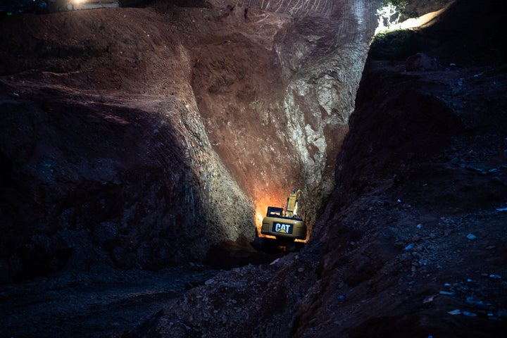 A tractor digs through a mountain during the rescue mission of a boy who fell into a hole in the northern village of Ighran in Morocco's Chefchaouen province, Friday, Feb. 4, 2022.