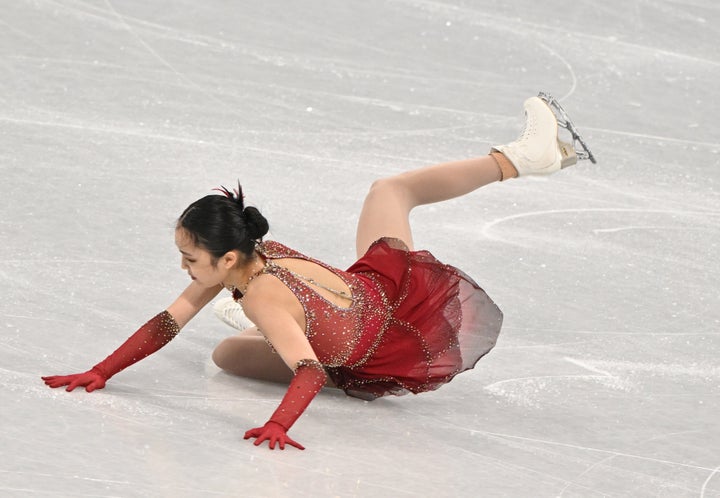 Zhu Yi falls Monday during competition in the Women's Single Skating Free Skating Team Event.