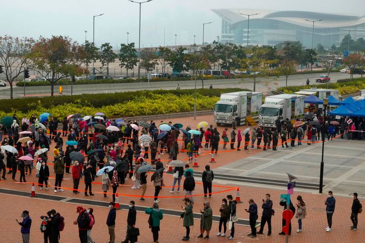 Residents line up to get tested for the coronavirus at a temporary testing center in Hong Kong on Monday, Feb. 7, 2022. The city has reported more than 300 local infections two days in a row, the highest since the pandemic began.
