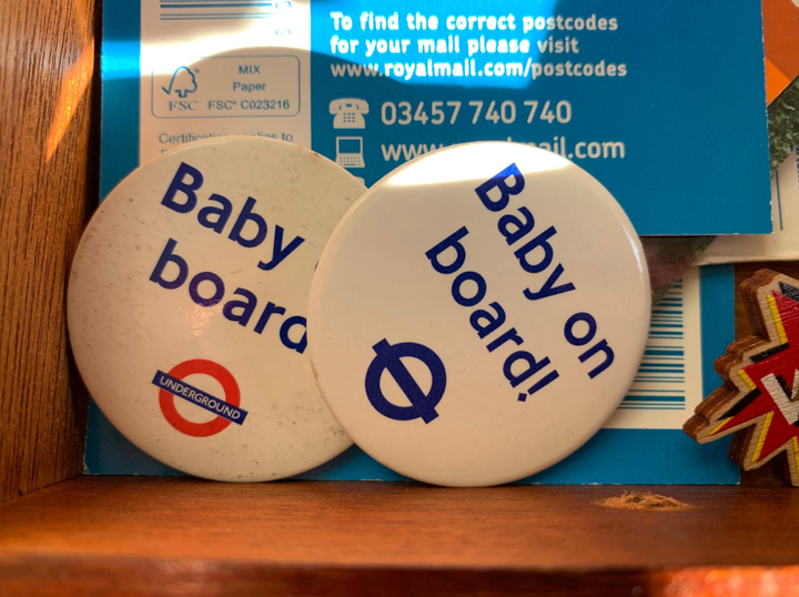 Badges often worn by pregnant people while riding public transportation in London.