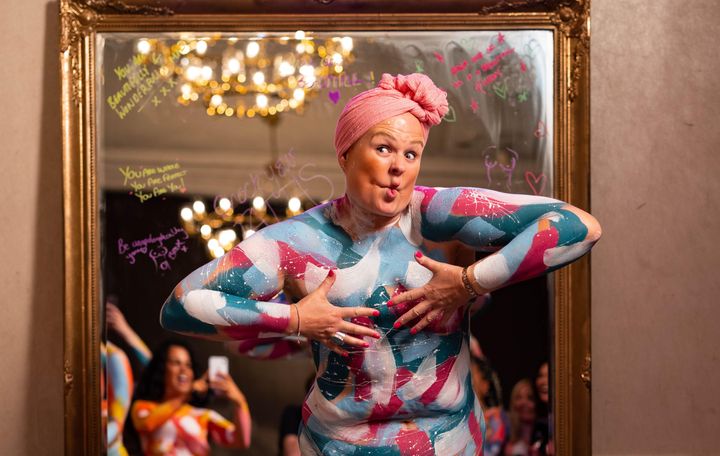 Breast cancer survivor Jo Knight poses at artist Sophie Tea's event.