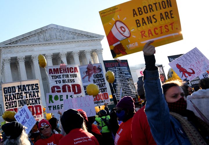 Abortion rights advocates and anti-abortion protesters demonstrate in front of the Supreme Court in Washington, D.C., on Dec. 1, 2021, as the justices hear oral arguments on whether to uphold a Mississippi law that bans abortion after 15 weeks and overrule the 1973 Roe v. Wade decision.
