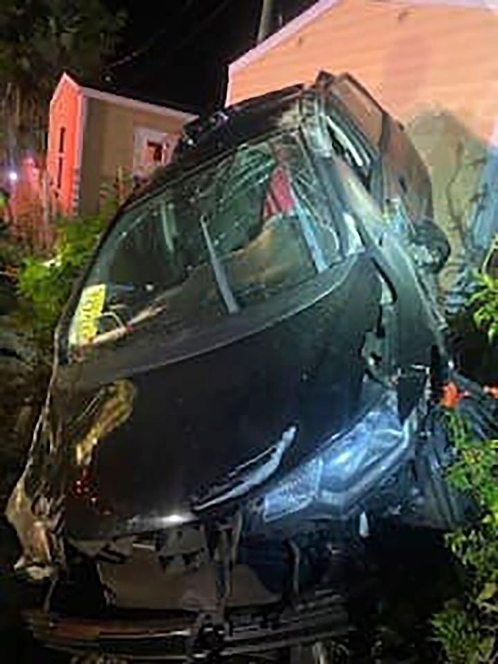This photo provided by the Martin County Sheriff’s Office shows a car destroyed after a collision with a train in Port St. Lucie, Fla. Saturday, Feb. 5, 2022. A Florida man says he jumped from the stolen car seconds before it was hit by a train and sent flying into a nearby home. The sleeping residents were unharmed and the man was later arrested, authorities said. (Martin County Sheriff’s Office via AP)
