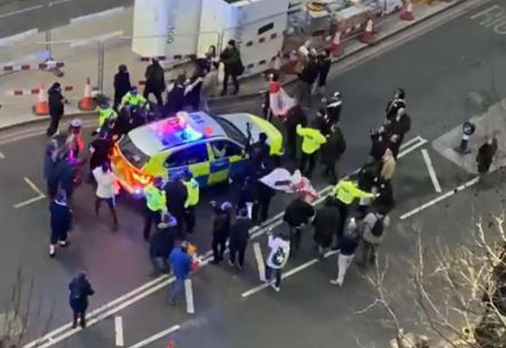 Clashes between police and protesters in Westminster as officers use a police vehicle to escort Labour leader Keir Starmer to safety.