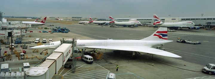 Just before their final flights August 26, 2003, two British Airways Concorde supersonic jets (one in the distance) stand at their gates with other standard passenger jets at Heathrow International Airport London, England.
