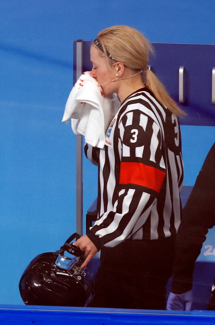 Referee Cianna Lieffers is assisted after she sustained an injury during play.