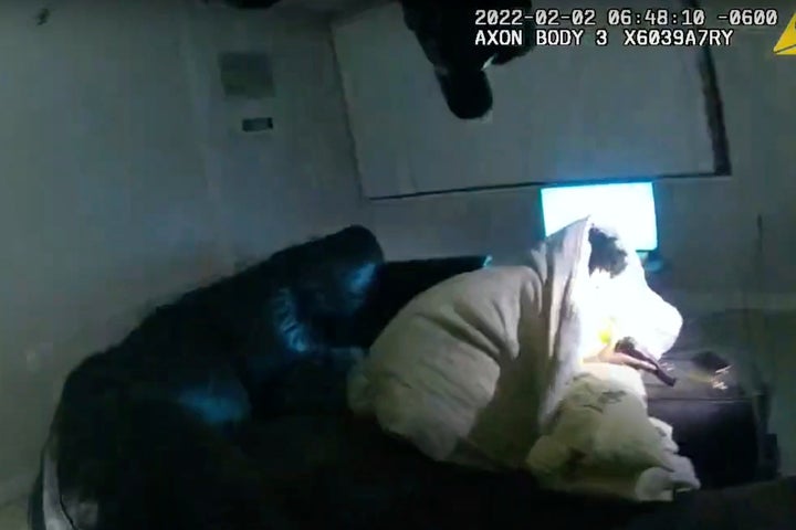 In this image taken from Minneapolis Police Department body camera video and released by the city of Minneapolis, 22-year-old Amir Locke is wrapped in a blanket on a couch holding a gun moments before he was fatally shot by Minneapolis police as they were executing a search warrant in a homicide investigation on Wednesday, Feb. 2, 2022, in Minneapolis. (Minneapolis Police Department via AP)