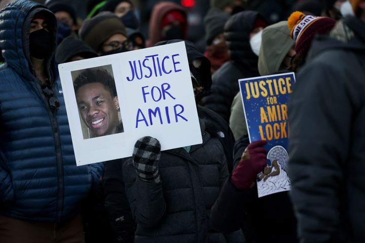A protester holds a sign demanding justice for Amir Locke at a rally on Saturday, Feb. 5, 2022, in Minneapolis. (AP Photo/Christian Monterrosa)