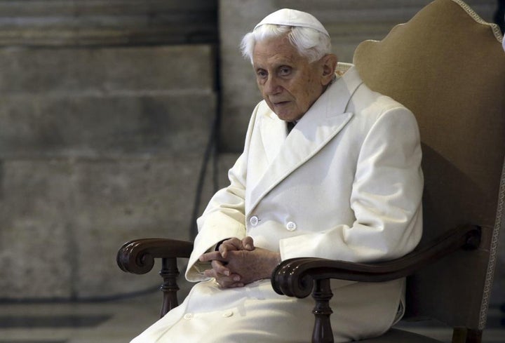This Dec. 8, 2015 file photo shows Pope Emeritus Benedict XVI sitting in St. Peter's Basilica as he attends the ceremony marking the start of the Holy Year.