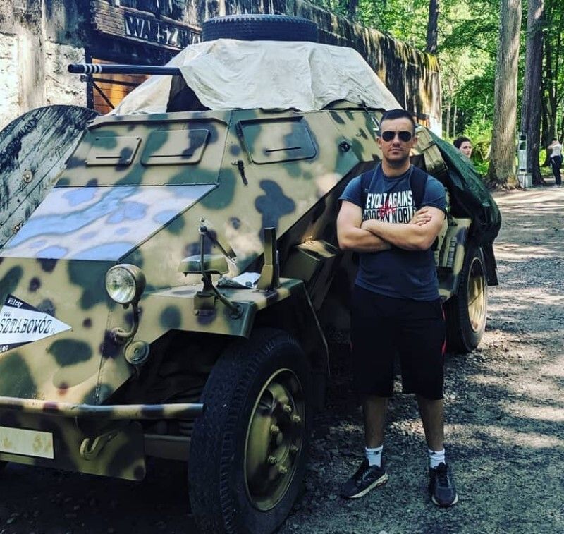 Andrew Sciulli, a former member of the Pennsylvania National Guard who allegedly belonged to the white supremacist group Patriot Front, poses with a tank at Wolf's Lair in Poland where Nazi leader Adolf Hitler was headquartered for part of World War II. Sciulli described the site as "sacred ground" in an Instagram post.