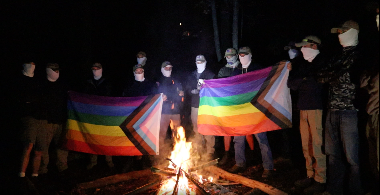 Some American fascists getting ready to burn a pride flag in the woods.