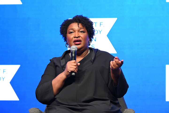 Stacey Abrams apologized on Tuesday for appearing maskless while posing for photos with masked schoolchildren last week.