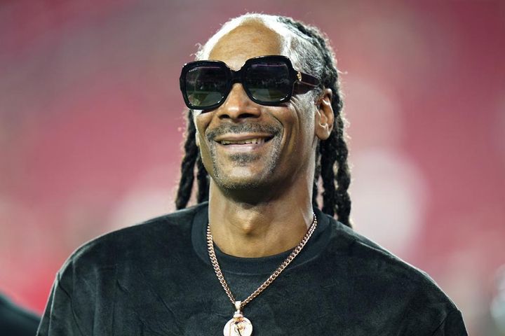 Snoop Dogg walks on the field before an NFL football game between the Tampa Bay Buccaneers and the New Orleans Saints on Sunday, Dec. 19, 2021, in Tampa.