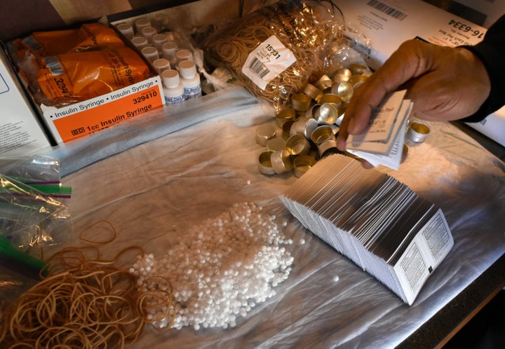 Kenneth Pierson puts together "harm reduction" kits for people who are addicted to heroin inside one of Baltimore City's needle exchange vans. 