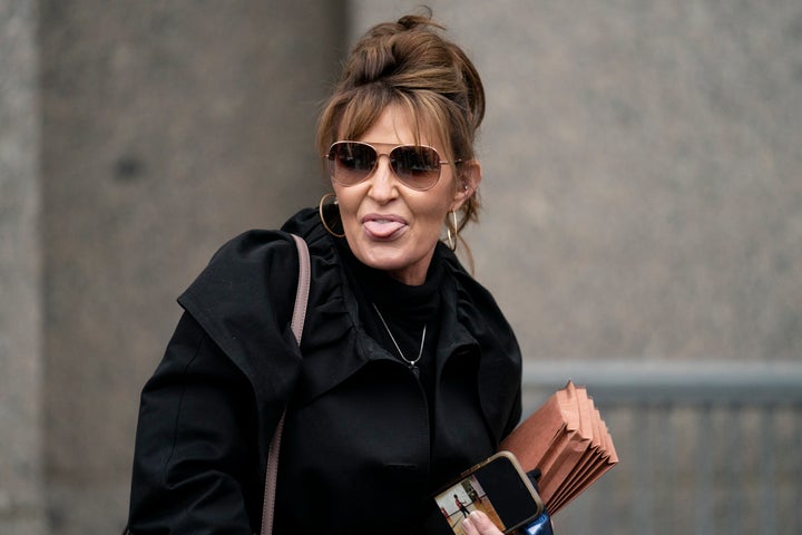 Former Alaska Gov. Sarah Palin (R) says hello to the press as she leaves the courthouse.