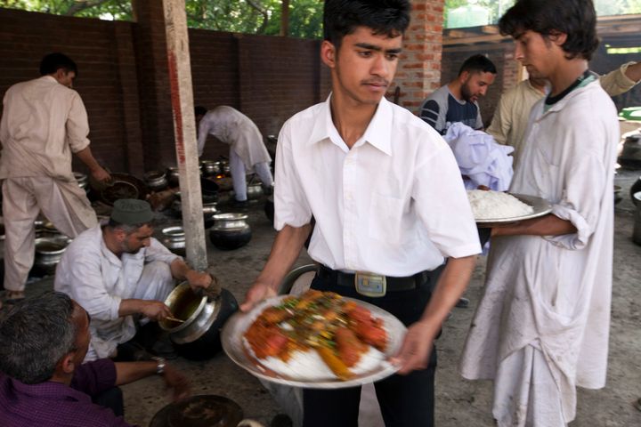Ένας σερβιτόρος παίρνει τα έτοιμα πιάτα από τους «Wazas» για να τα σερβίρει