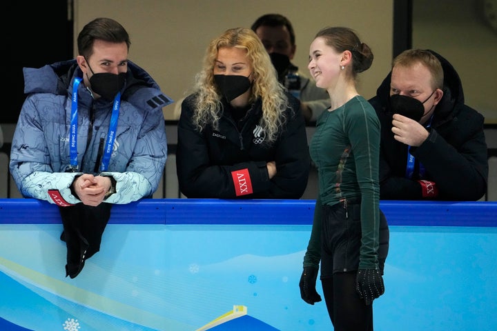 Kamila Valieva talks to coaches at a Thursday training session at the Beijing Winter Olympics.