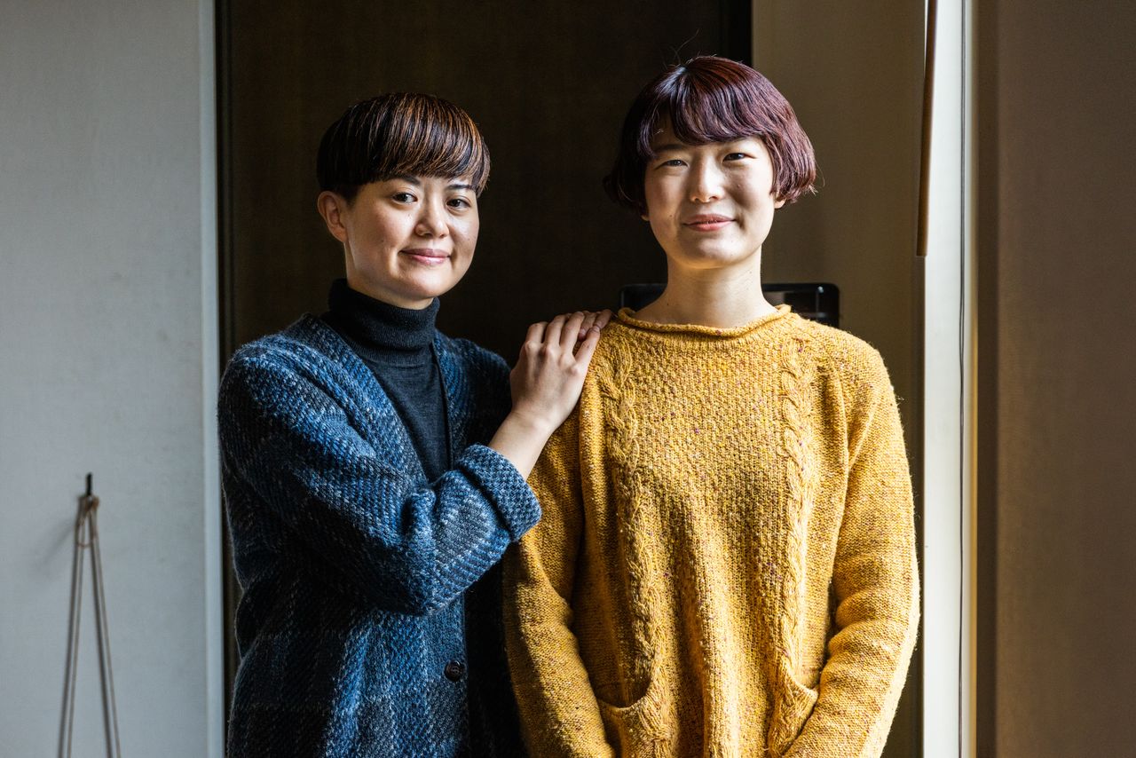 Soyoka Yamamoto, left, and her partner, Yoriko, pose for a portrait at their home on Dec. 14, 2021, in Tokyo.