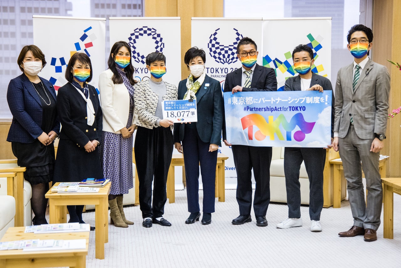 Soyoka Yamamoto, center left, hands a letter of request and a petition signed by over 10,000 people to Tokyo Gov. Yuriko Koike, center right, at the Tokyo Metropolitan Government building on March 22, 2021.