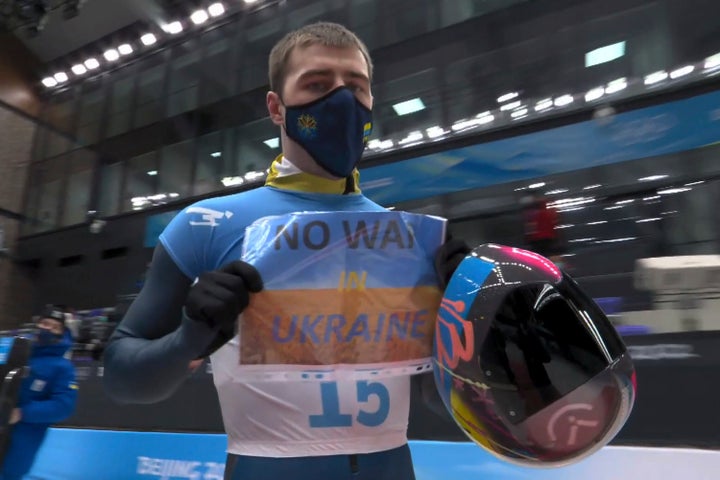 Vladyslav Heraskevych held a sign that read "No War in Ukraine" after finishing a run at the men's skeleton competition at the 2022 Winter Olympics.