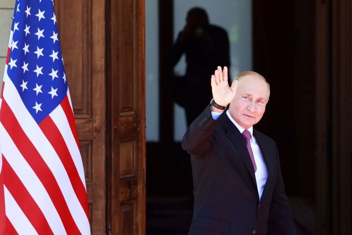Russia's President Vladimir Putin waves as he arrives at Villa La Grange for the U.S.-Russia summit with US President Joe Biden in Geneva, on June 16, 2021.