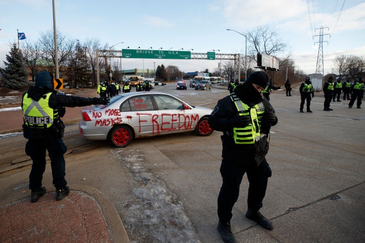 Police clear protestors and their vehicles from a blockade at the entrance to the Ambassador Bridge, that was sealing off the flow of commercial traffic over the bridge into Canada from Detroit, on February 12, 2022 in Windsor, Canada. As a convoy of truckers and supporters continues to occupy Ottawas downtown, blockades and convoys have popped up around the country in support of the protest against Canadas COVID-19 vaccine mandate for cross-border truckers. (Photo by Cole Burston/Getty Images)