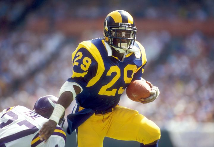 Eric Dickerson rushes with the ball in his NFL heyday with the Rams.