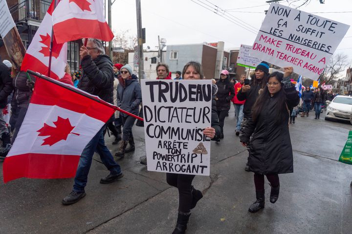 Protesters against COVID-19 restrictions march through the streets of Montreal on Saturday, Feb. 12, 2022. (Peter McCabe /The Canadian Press via AP)