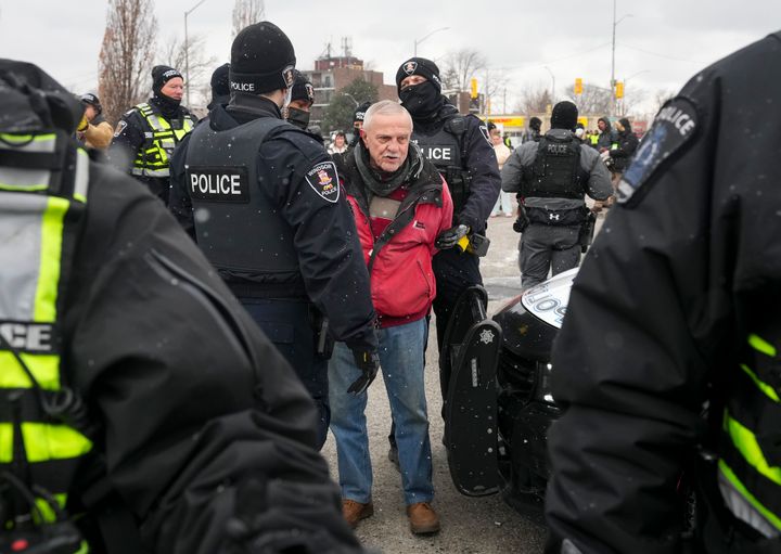 A protester is arrested in Windsor, Ontario on Sunday, Feb. 13, 2022. (Nathan Denette/The Canadian Press via AP)