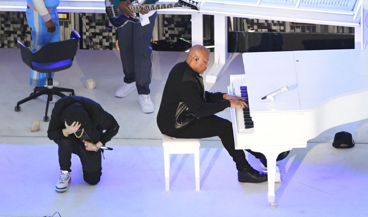 Eminem takes a knee as he performs alongside Dr. Dre during the halftime show of Super Bowl LVI at SoFi Stadium in Inglewood, California, on Feb. 13.