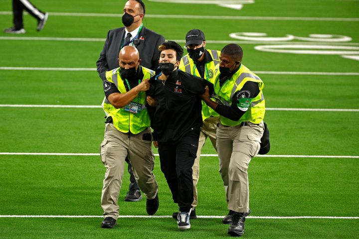 Security escorts a fan off the field during Super Bowl LVI on Feb. 13.